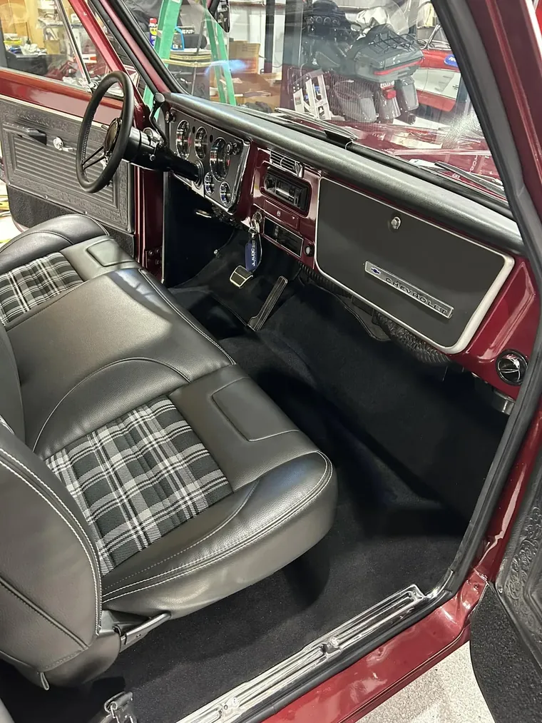 Chevrolet C10 interior with bench seat, painted dash, and carpet